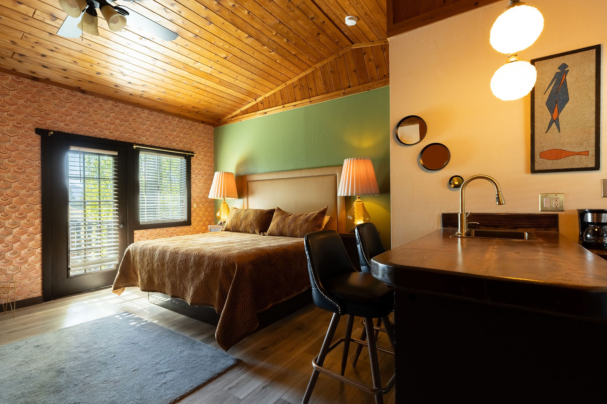 Log Cabin spa suite — pine paneling, stone jet tub, oval wood mirror