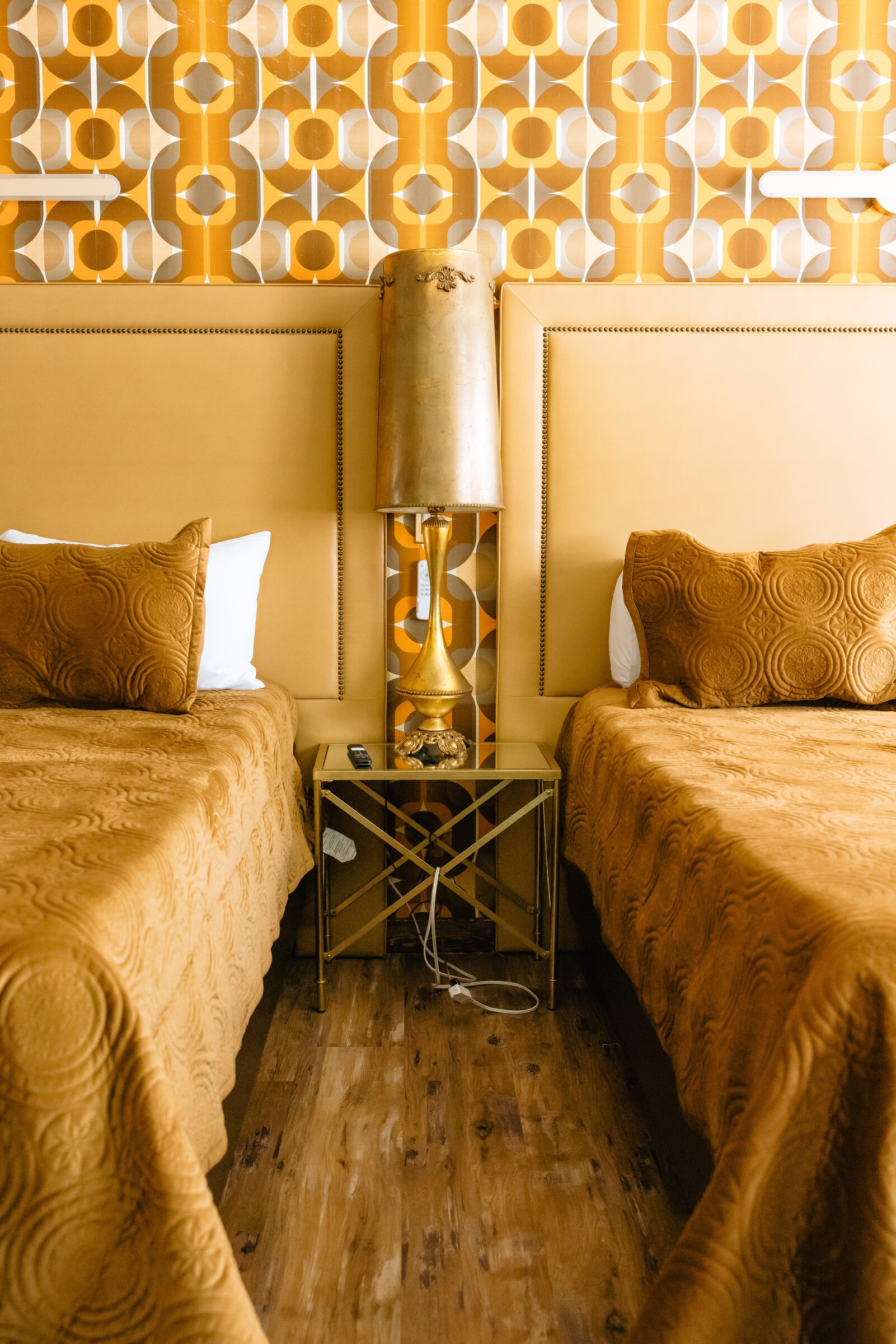 Mustard honeycomb-velvet headboard with retro circle wallpaper — Loft room